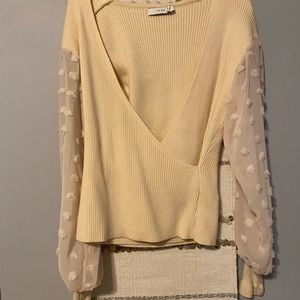 LUSH sweater top with sheer sleeves and polka dot details.